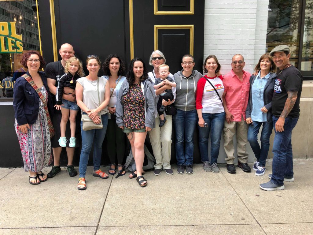 The Carter extended family standing together, smiling, on the sidewalk
